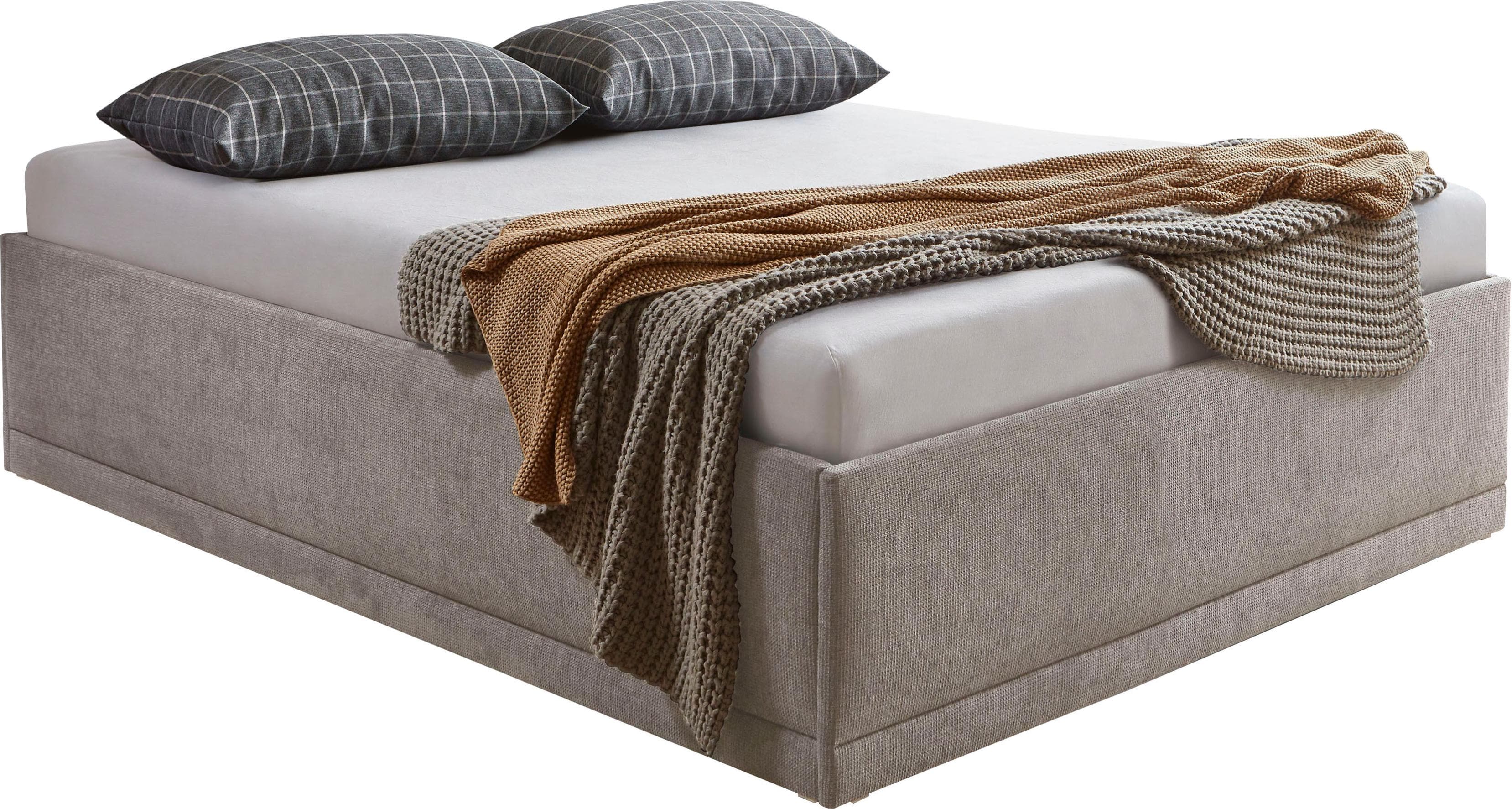 Polsterbett mit Zierkissen und Bettkasten